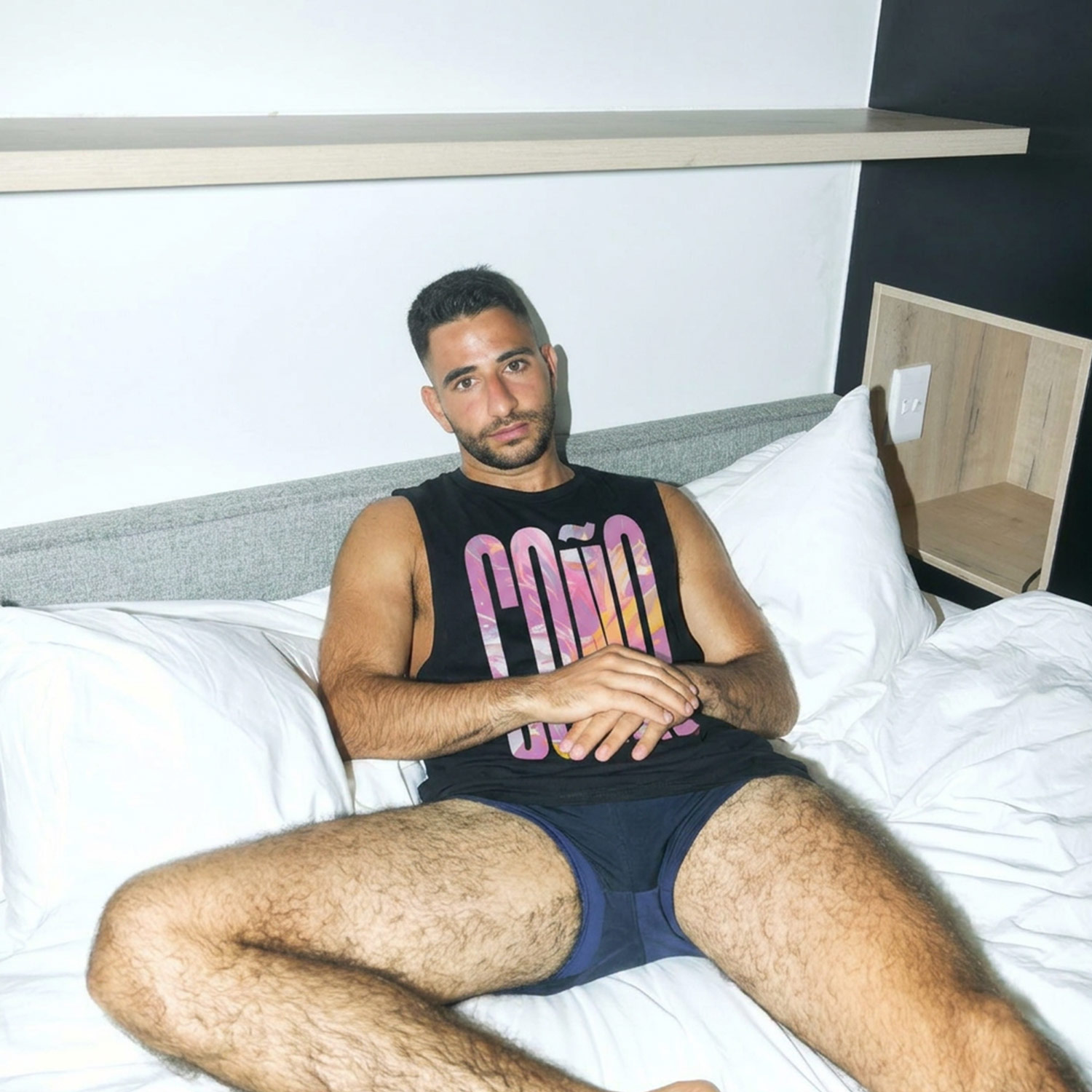 Torso shot of black Gayer Things Coño muscle shirt with denim — marble typography detail