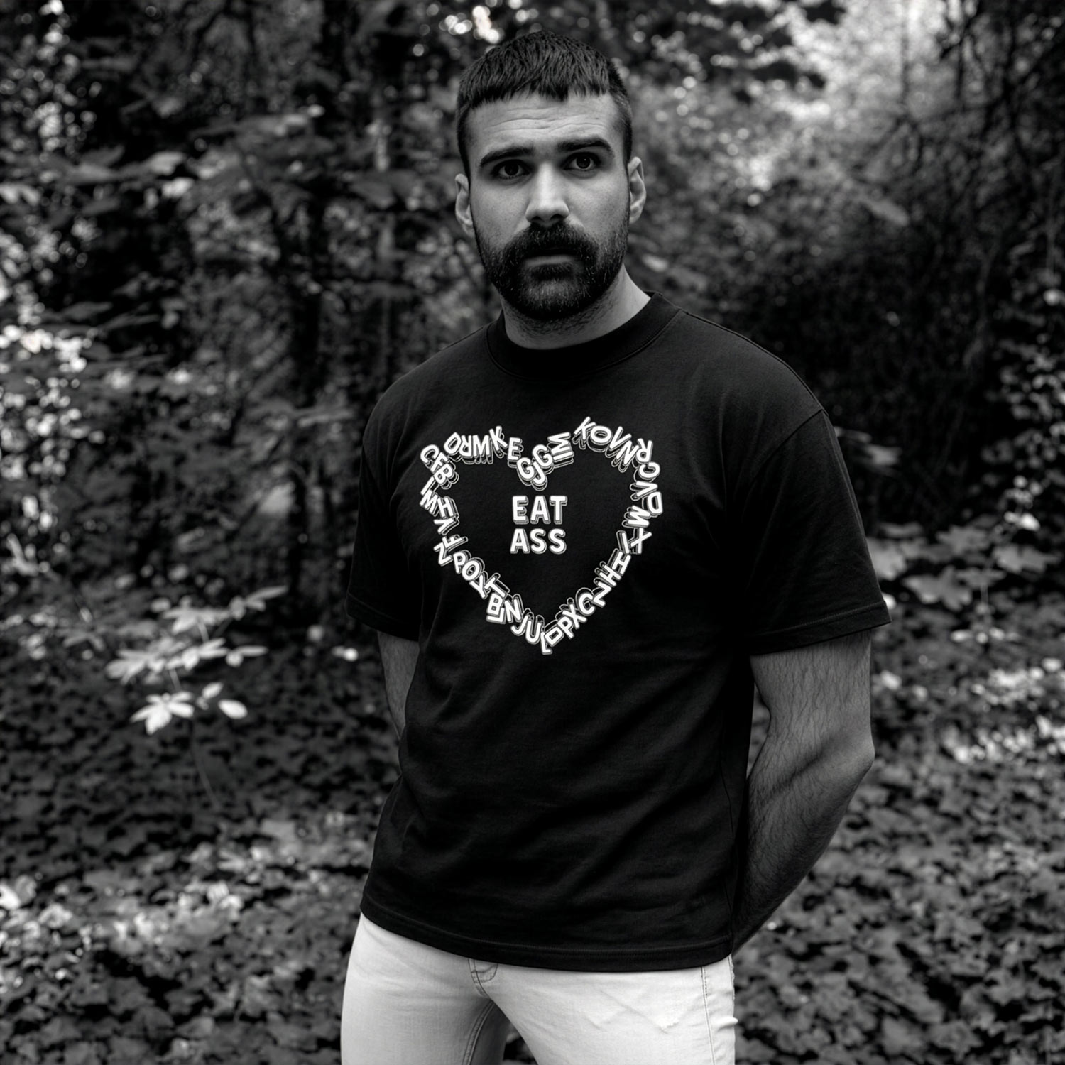 Model in black Gayer Things Eat Ass oversized T-shirt — lifestyle streetwear angle