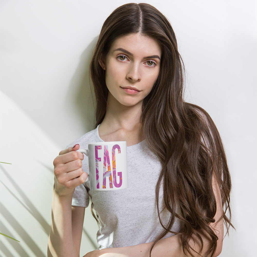 Model holding Gayer Things queer streetwear mug, showing scale and everyday pride accessory styling