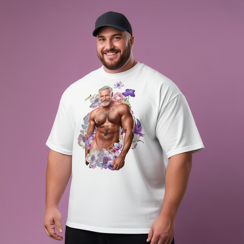 Model in black cap wearing white Himbo Dan oversized T-shirt — lilac studio backdrop, floral wreath graphic
