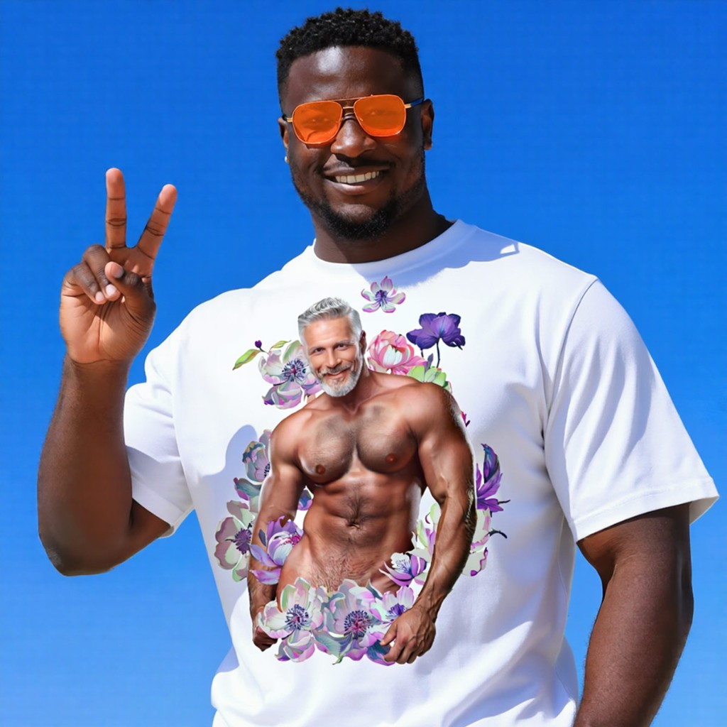 Smiling model outdoors in white Himbo Dan organic oversized tee — blue sky, peace sign, purple-pink floral chest print