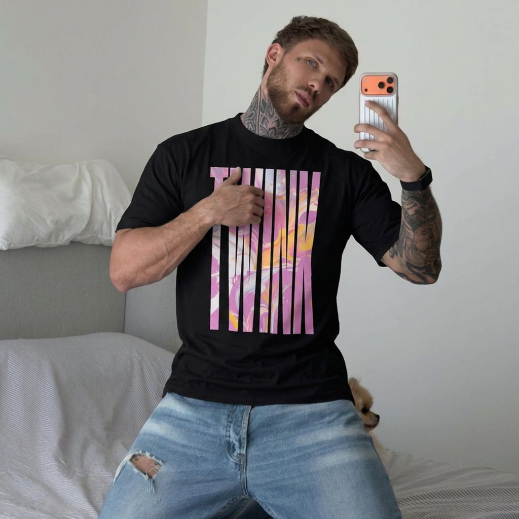 Black Gayer Things Twink oversized tee on rainbow tunnel studio backdrop — bold marble TWINK typography