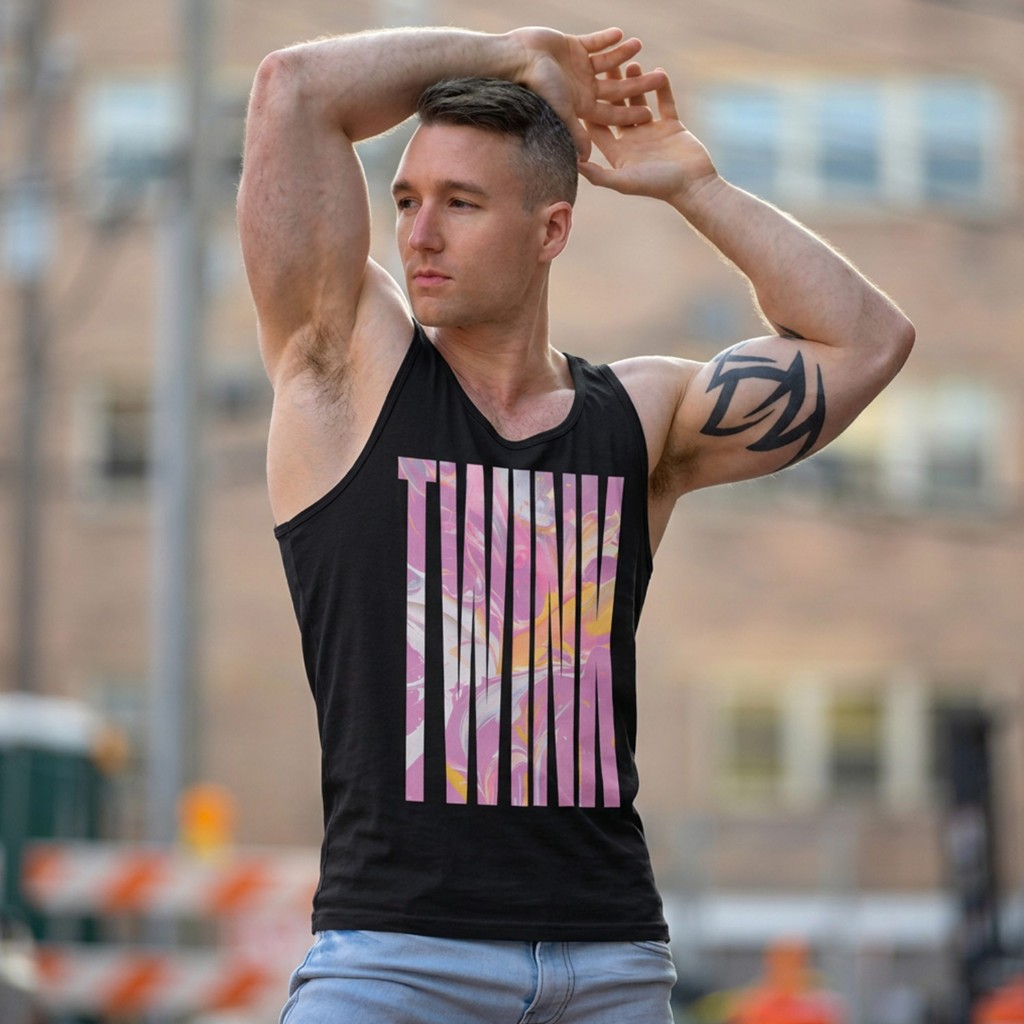 Muscular model in black Gayer Things Twink tank outdoors — arms raised, marble TWINK chest print, urban street blur